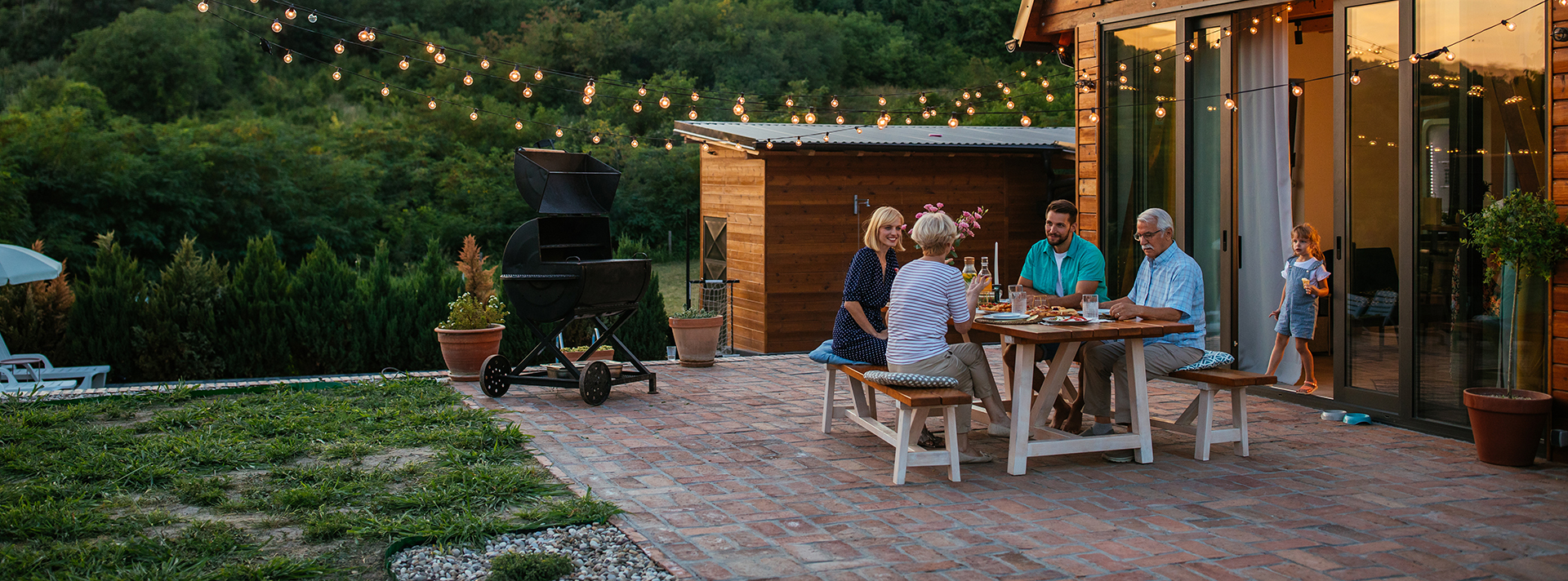 Family dinner around dining table in the garden